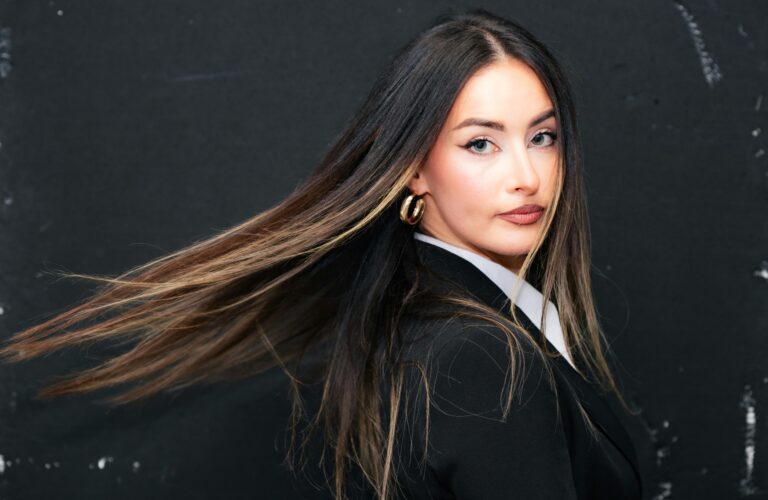 Portrait of a stylish woman with long flowing hair and a serious expression in Munich.